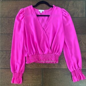 Hot pink cropped, semi-sheer blouse.